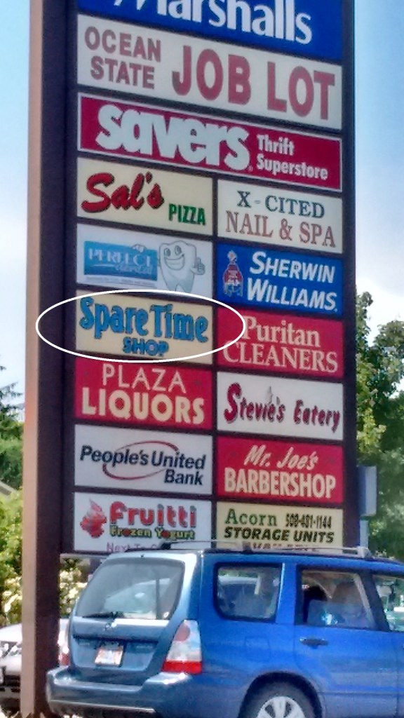 Finally! A store that's selling something we can all really use. Check out the circled sign, lost in a jumble of useless shops.